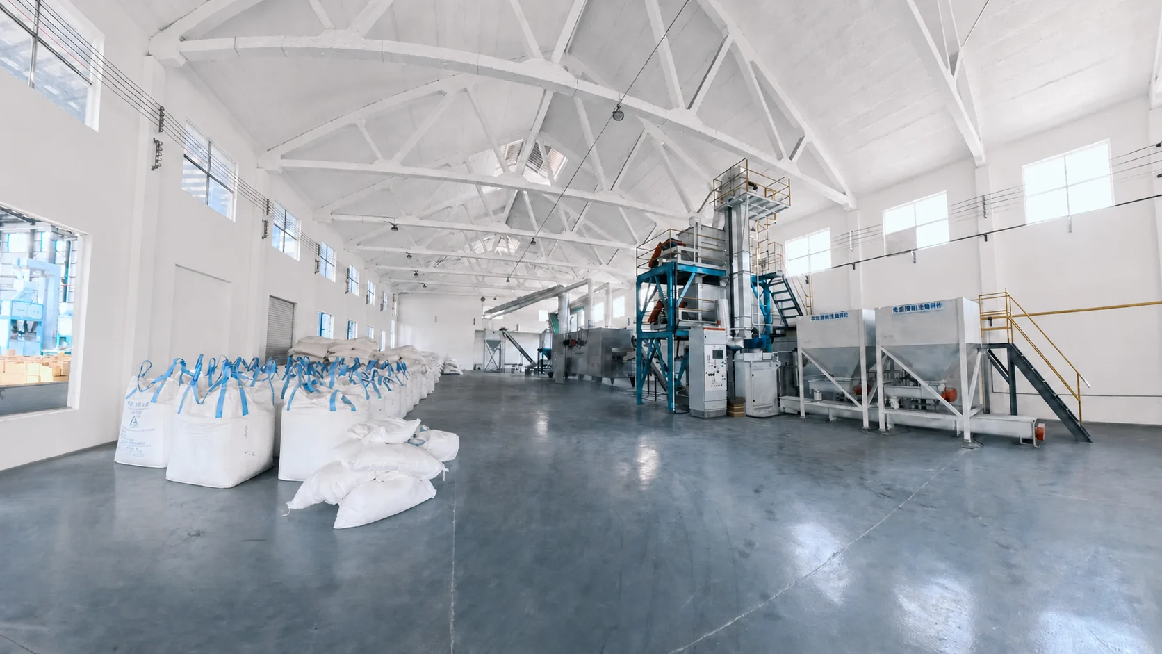 CleanPaw Island cat litter production hall with raw material bags and processing equipment