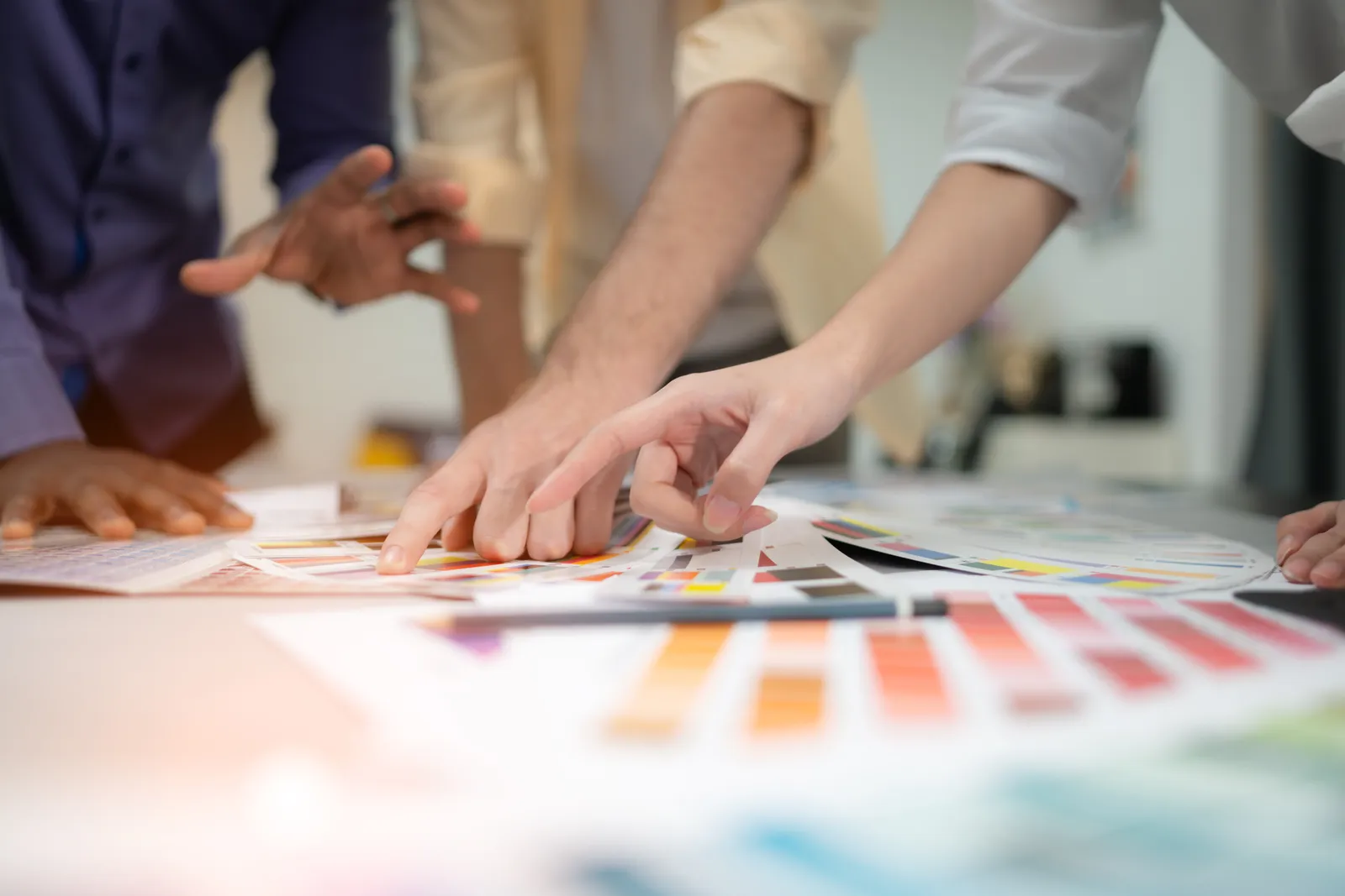 Team reviewing packaging color swatches on a worktable